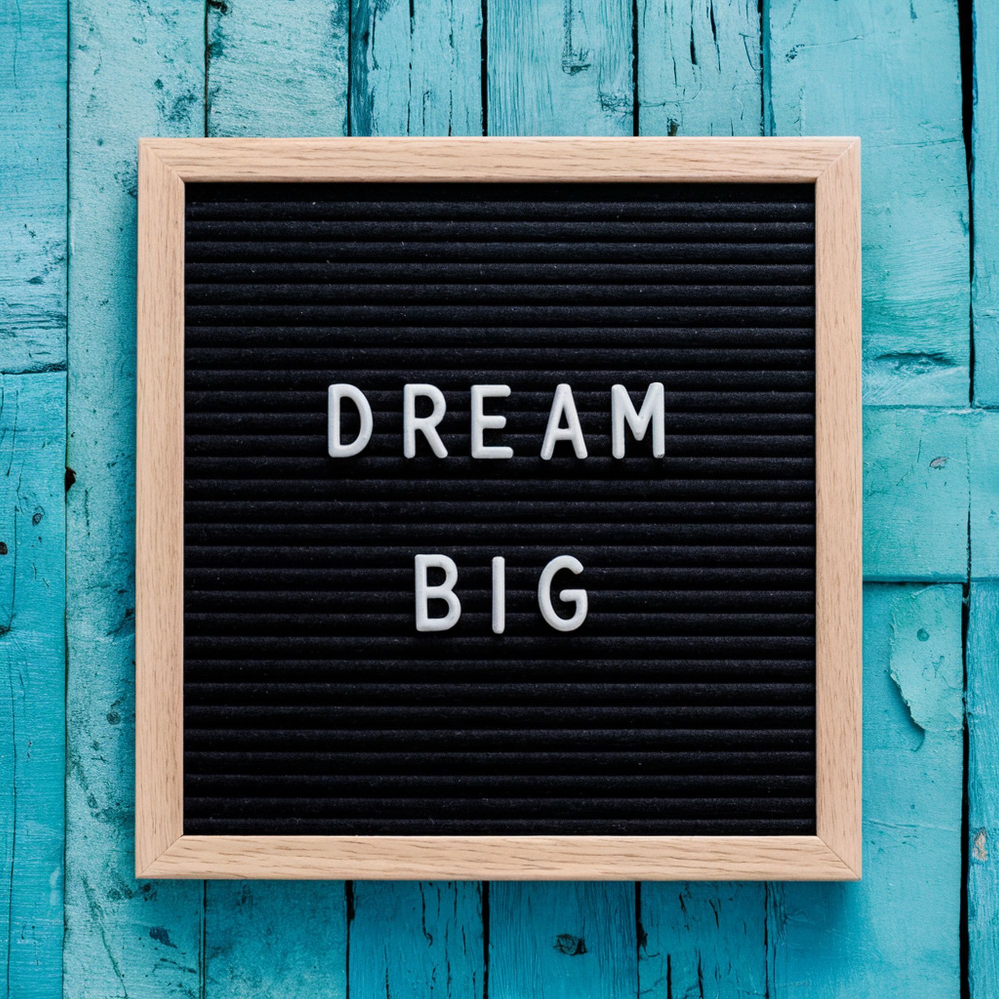 Letter Board Against Blue Wood