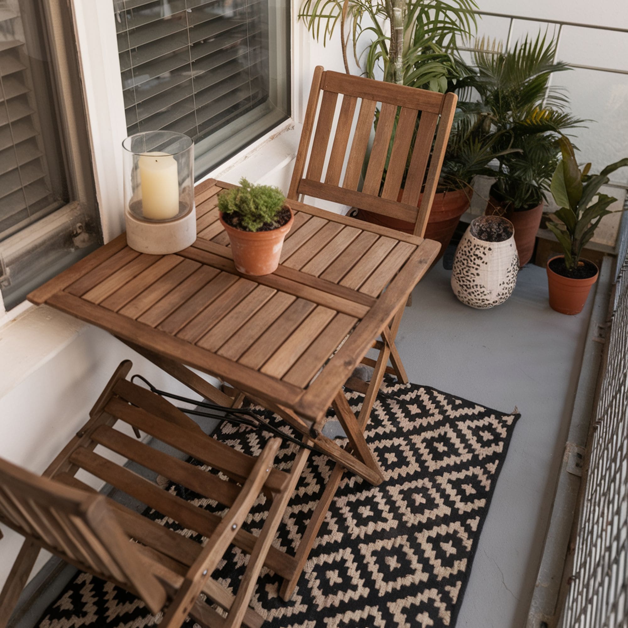 Apartment Balcony With Folding Chairs and Table