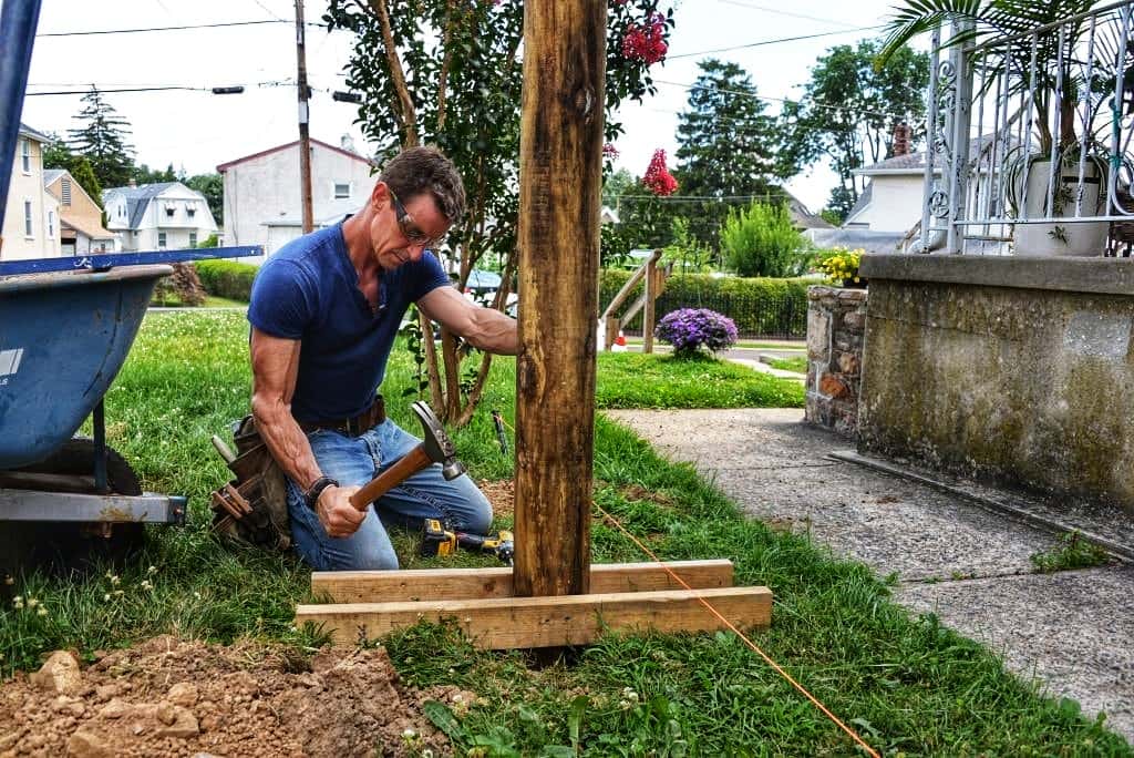 Lowering Fence Post in Hole
